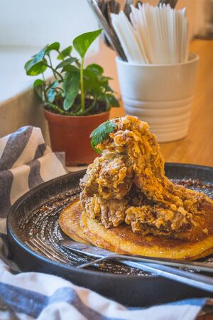Fried chicken on house-made buttermilk pancakes served with chilli maple