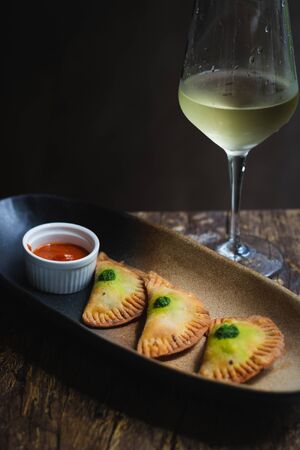 Chicken Empanadas La abuela style pastry puffs, spinach, green chimichurri sauce