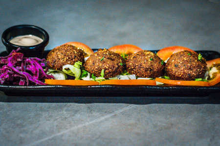 a serving of Hot Mezza - Falafel served with  tomatoes, lettuce and red cabbageの写真素材