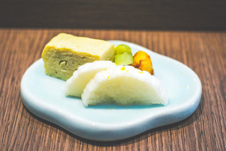 a small serving of japanese white radish pickles and pickled egg served on a small dish