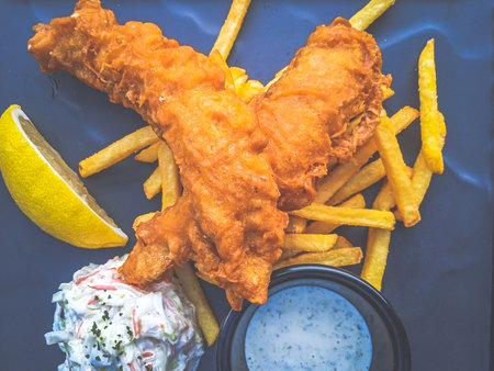Barramundi Fish & Chips served with fries , coleslaw and a lemon wedge