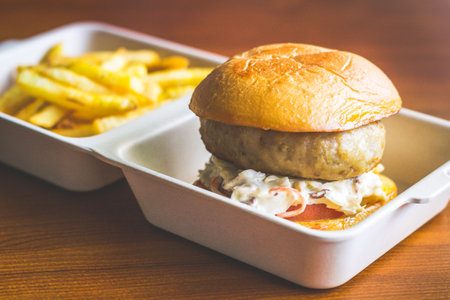 Cheese Stuffed Pork Burger with Cheesy stuffed patty and served with coleslaw and french friesの写真素材