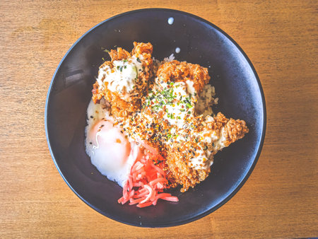 Nanban Chicken Rice Bowl with onsen half boiled egg and pickled gingerの写真素材