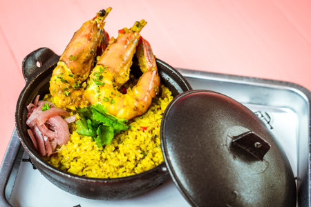 rice cooked in Lemak Chilli Padi sauce with tiger prawns and  pickled onions on top