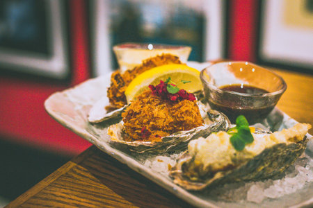 fried oysters including KAKI FRY made from oyster panko, egg mayo & lemon, OYSTER FRITTO with battered oyster & yuzu kosho mayo, CREAM KOROKKE with bechamel, chuno sauce & shibazukeの写真素材