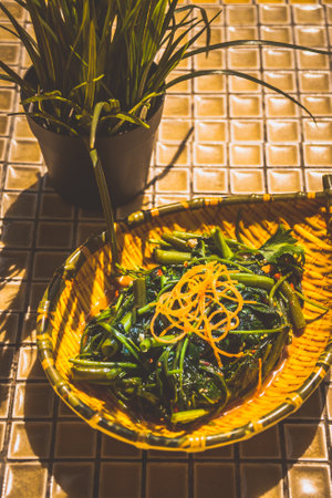 Stir-fried Kang Kong with Chili Padi served in a rustic plateの写真素材