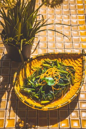 Stir-fried Kang Kong with Chili Padi served in a rustic plateの写真素材