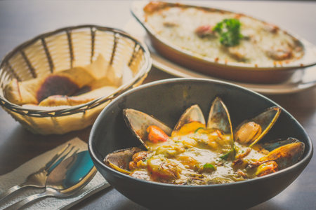 Curry Mussels in a bowl and Served with pita breadの写真素材