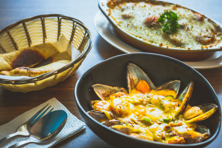 Curry Mussels in a bowl and Served with pita breadの写真素材