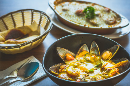 Curry Mussels in a bowl and Served with pita breadの写真素材