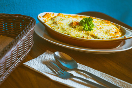 Gulai Salmon Baked Rice Rice baked in creamy and flavourful gulai Padang sauce with salmon and topped with cheeseの写真素材