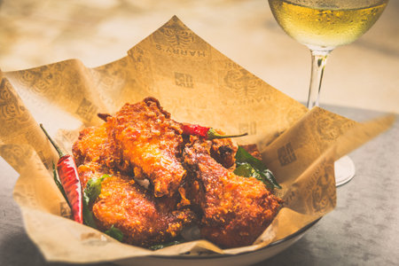 fried chicken wings with curry leaves and chilli served in a bowlの写真素材