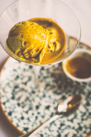 Affogato Al Pistachio with Pistachio gelato, espresso served in a martini glassの写真素材