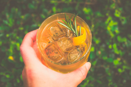 a cocktail made from Whisky, Home-madeInfused Rosemary Syrup, Bitters served in a glass