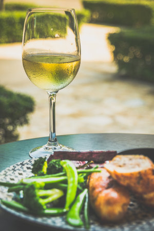 Roasted Chicken Roulade Roasted sweet potatoes, steamed green vegetables, chimichurri sauceの写真素材