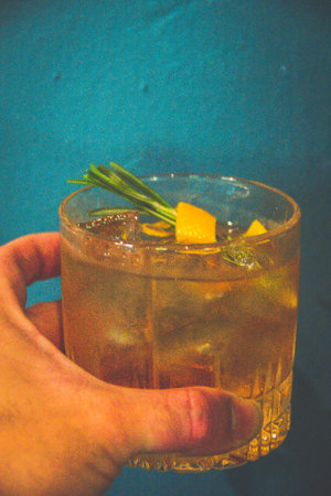 a cocktail made from Whisky, Home-madeInfused Rosemary Syrup, Bitters served in a glass