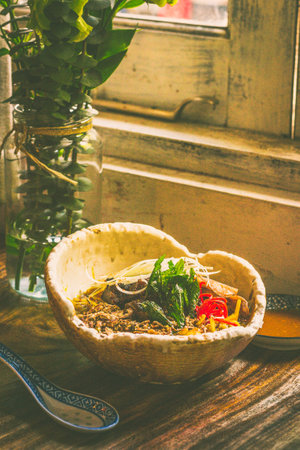 US Rib Fingers with curry mee tai mak, fukujinzuke, quail egg, tendon, tripe, daikon, fermented...