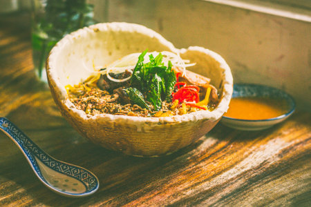 US Rib Fingers with curry mee tai mak, fukujinzuke, quail egg, tendon, tripe, daikon, fermented tomato chiliの写真素材