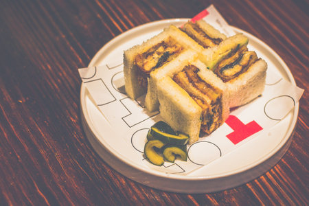 Japanese Unagi Sandwich served on a white plate on a table