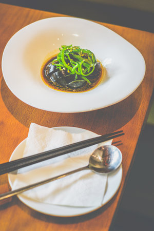 chopped slices of century Eggs With Grilled Chillies served in a white plateの写真素材