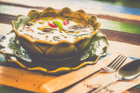 Thai Green Curry With Chicken with baby eggplant and herbs served in a bowlの写真素材