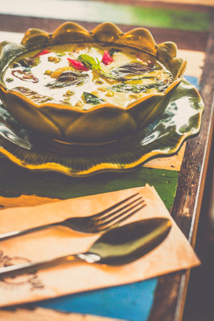 Thai Green Curry With Chicken with baby eggplant and herbs served in a bowlの写真素材