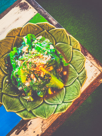 Kailan stirfried  With Oyster Sauce and served in a green dishの写真素材