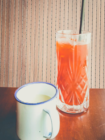 thai Milk Tea served with ice in a glass with milk on the sideの写真素材