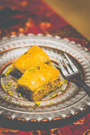 Baklava (2 Pieces) A rich homemade dessert made with Turkish filo pastry and pistachios. Sweetened with syrupの写真素材