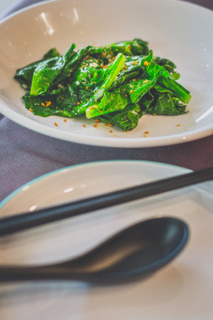 Stir-Fried Kailan with Minced Garlic served in a white plate
