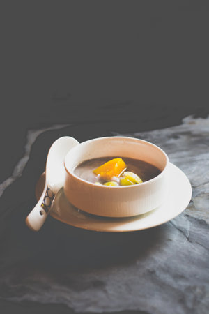MASHED TARO 'ORH NEE' with sweet potato chunk and gingko nuts in a white bowlの写真素材