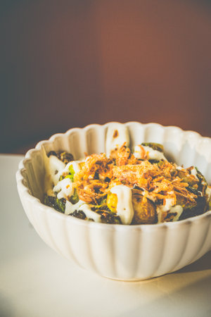 Burnt Brussels Sprouts with Char, Cream, and Umami Honey miso glaze, sour cream, fried shallots,...