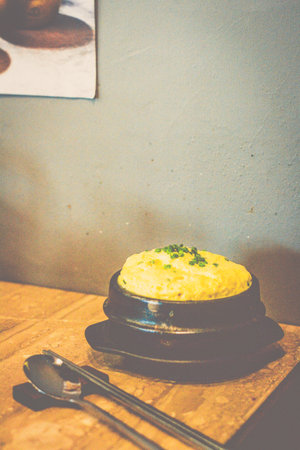 steamed egg custard in a black bowl on a table