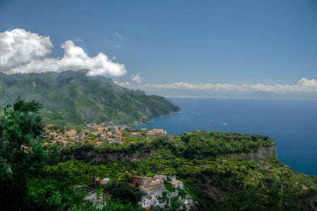 landscape made in the upper area of the Amalfi coast, with the main colors of the coast the green of nature, the blue of the sea and the blue of the skyの写真素材