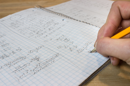 Hand writing in notebook full of messy mathの写真素材