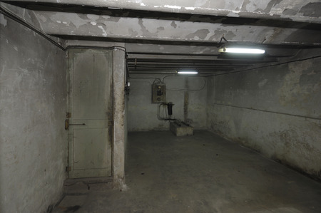Old and outdated room in the basement of a house with electric installationの写真素材