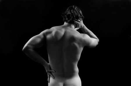 Muscular man with back pain, isolatedの写真素材