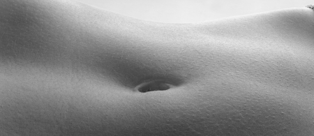 detail the navel of a woman with white background