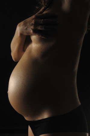pregnant woman with black backgroundの写真素材