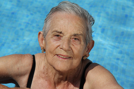 Senior Woman Having Fun In Swimming Poolの写真素材