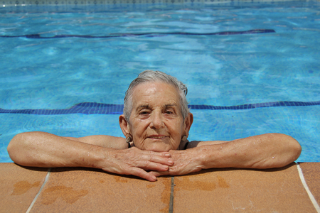 Senior Woman Having Fun In Swimming Poolの写真素材
