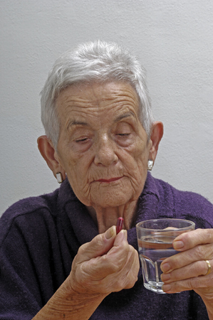 senior woman taking pillsの写真素材
