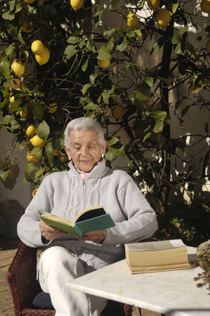 old woman reading a bookの写真素材