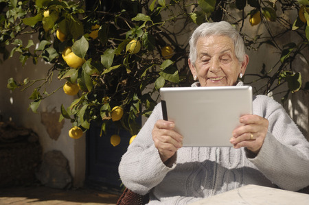 old woman and tabletの写真素材