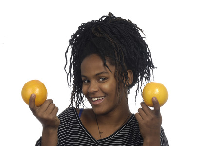 Teenage girl playing with an orange,の写真素材
