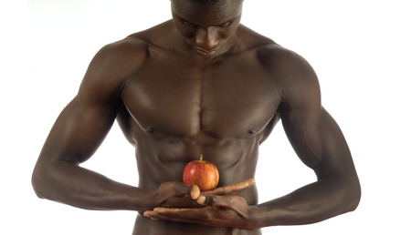 African man with an apple on whiteの写真素材