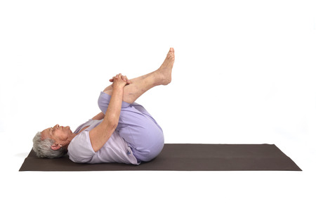 Senior woman doing yoga, isolatedの写真素材