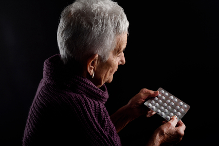 Senior woman with blister medicationsの写真素材