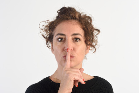 Woman with silence sign on white bacdgroundの写真素材