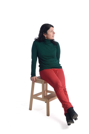 Portrait of a woman sitting with white backgroundの写真素材